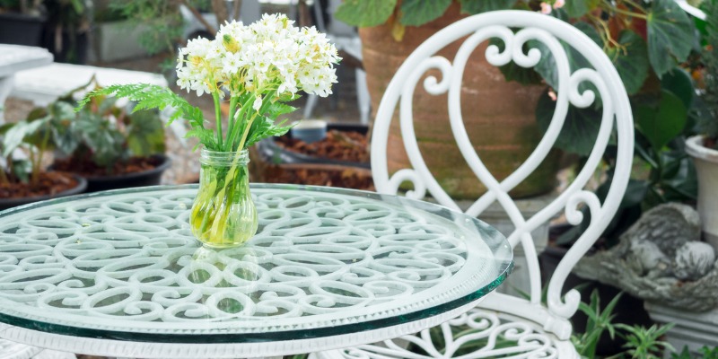 Wrought iron white table with white flowers on top
