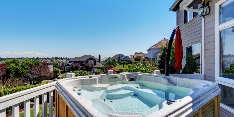 Open Hot Tub looking over green landscaping in the Summer