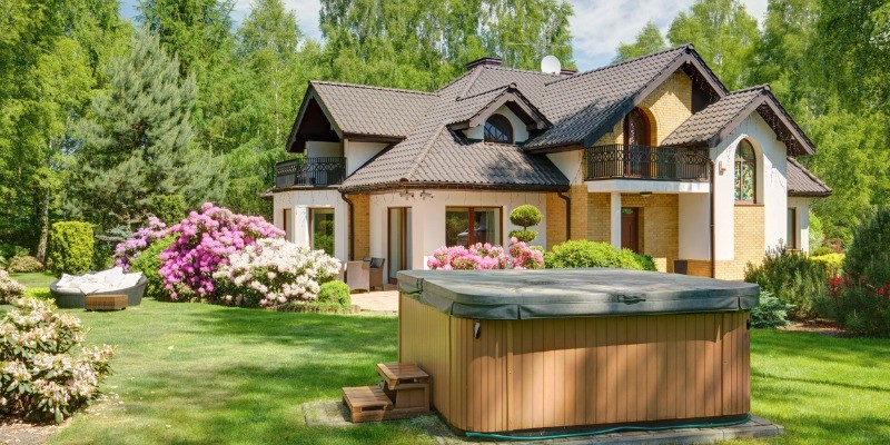 Closed hot tub in a backyard during the spring