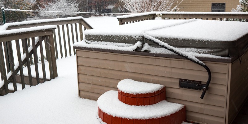 snow covered hot tub with heat shield