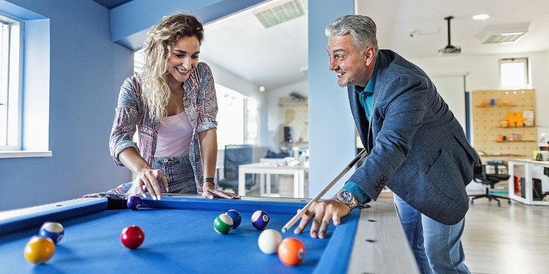 Man and woman playing pool together