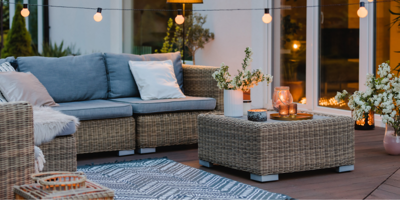 Patio seating area with accessories at dusk - Must-have Patio Accessories for 2023: Your Ultimate Guide