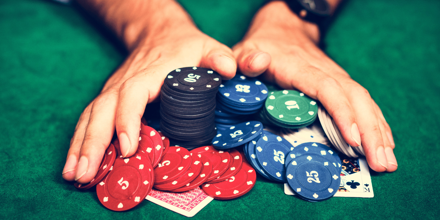 Moving poker chips along a table with both hands - 5 Different Poker Games for Your Next Poker Night 